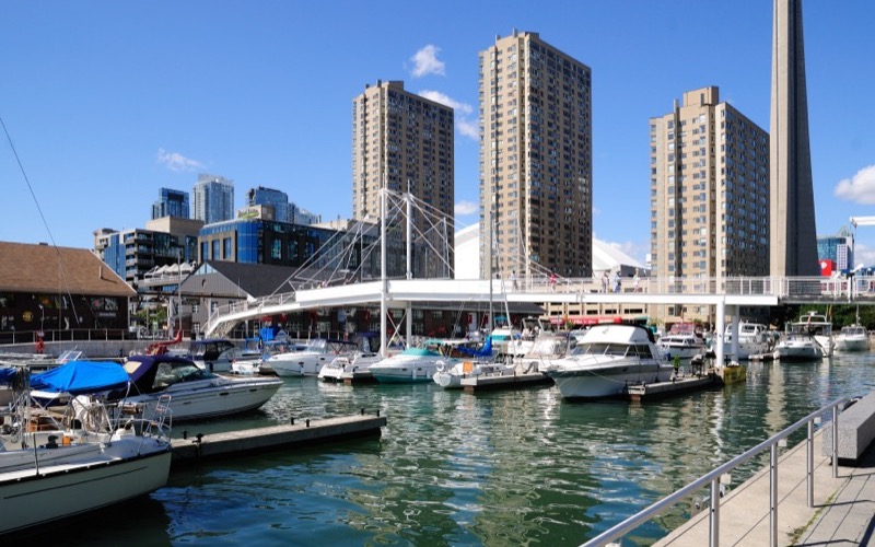 Boats in the Toronto Harbourfront marina with condominium towers and the CN Tower behind